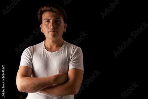 portrait latin man with crossed arms in studio black background