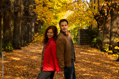 people in fall, couple in love man and woman joke and laugh in autumn © galina