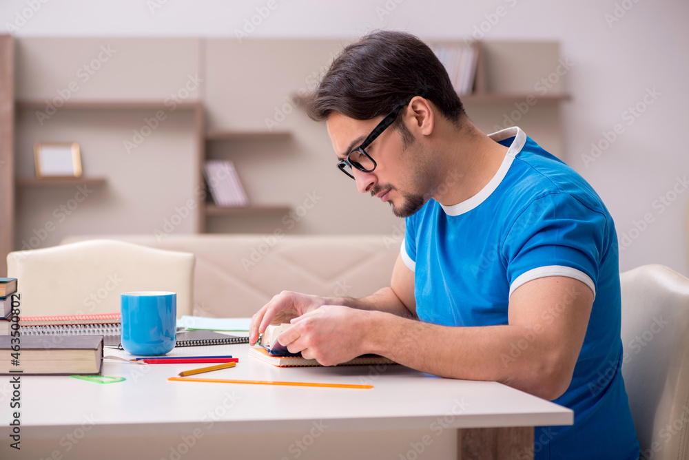 Young male student studying at home Young male student studying at home