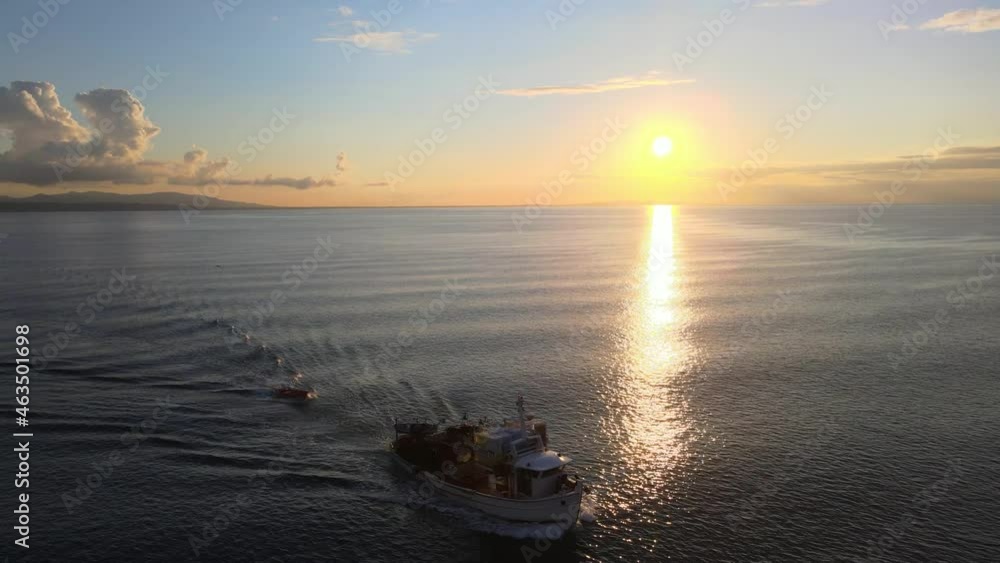 A fishing boat sailing at the beautiful blue sea.Beautiful clouds and blue sky at the sunset time.Very nice aerial sea drone footage A fishing boat sailing at the beautiful blue sea.Beautiful clouds and blue sky at the sunset time.Very nice aerial sea drone footage