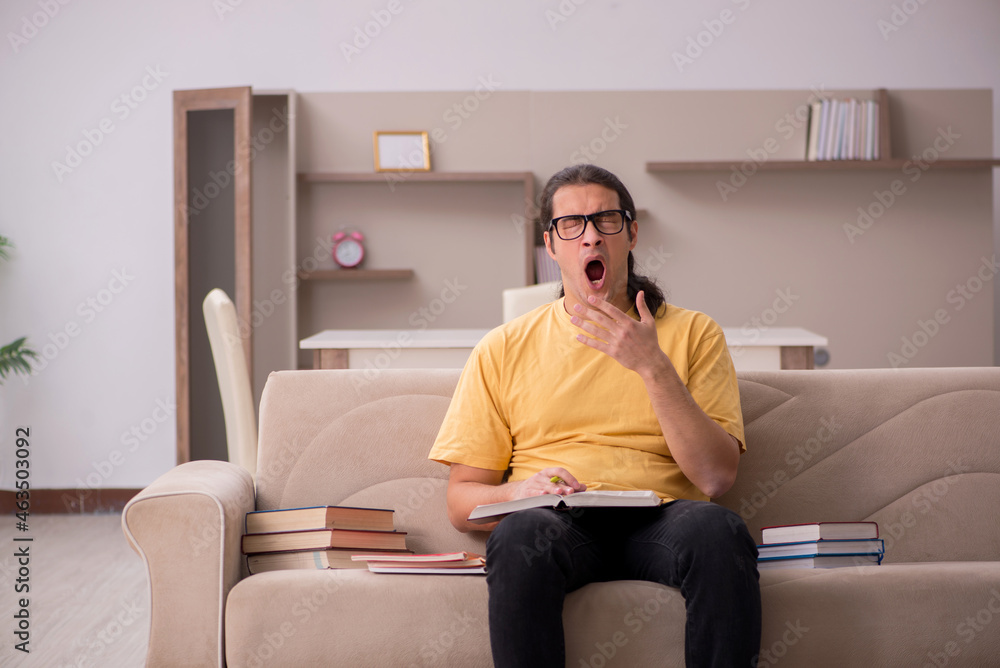 Young male student preparing for exams at home Young male student preparing for exams at home