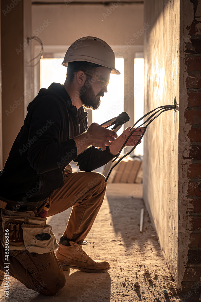 Fototapeta premium Worker is cutting wires with lineman's pliers.