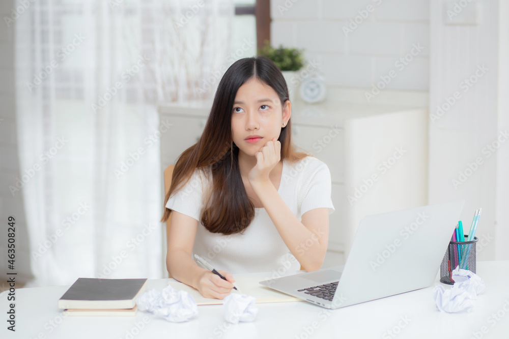 Young asian woman working with laptop computer think idea project and paper crumpled having problem on table at home, girl using notebook with frustrated and trouble, business and freelance concept. Young asian woman working with laptop computer think idea project and paper crumpled having problem on table at home, girl using notebook with frustrated and trouble, business and freelance concept.