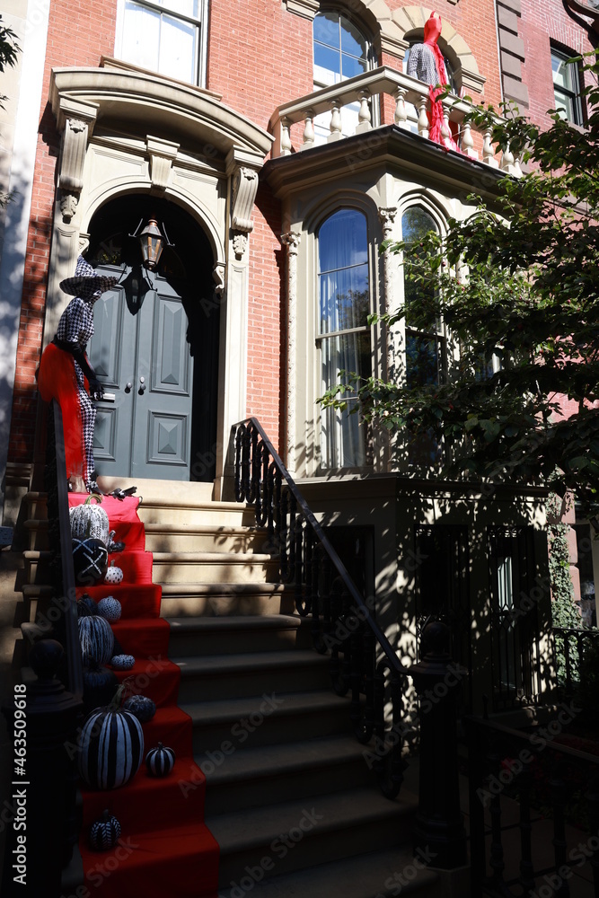 A townhouse with Halloween pumpkins and Halloween decorations in the evening on a city street. Trick or treat..