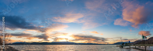 Yukon, Canada - 16th October 2021: Panoramic nature sunset in northern Canada taken during fall, autumn over a stunning lake with blue sky and dock.  © Scalia Media