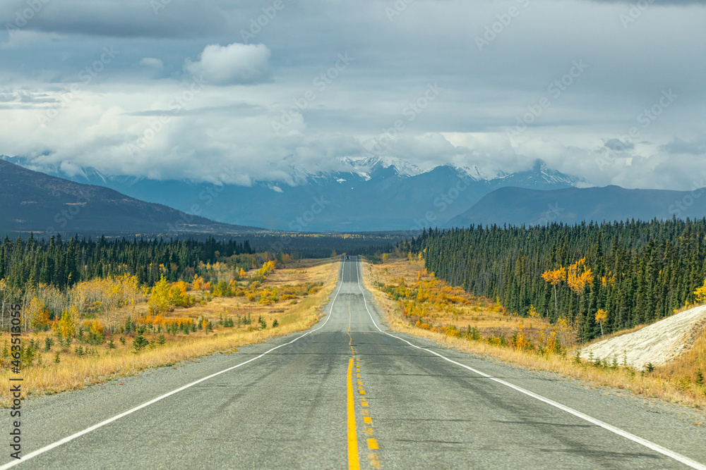 Road trip, tourism, travel themed shot heading directly towards huge mountain landscape in fall, autumn during September in northern Canada, Yukon Territory, Haines Junction. 