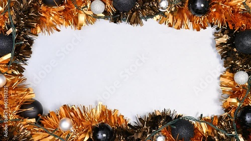 Making modern orange black Christmas frame with blinking lights. Stop motion