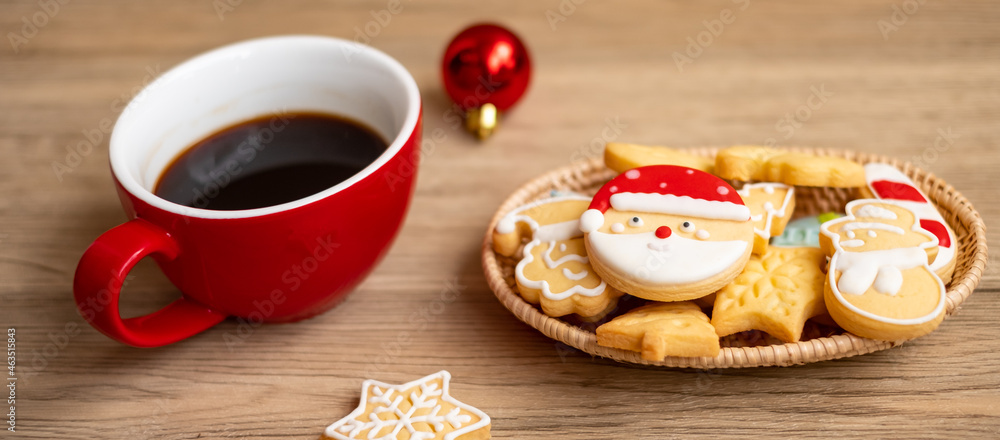 Merry Christmas with homemade cookies and coffee cup on wood table background. Xmas eve, party, holiday and happy New Year concept