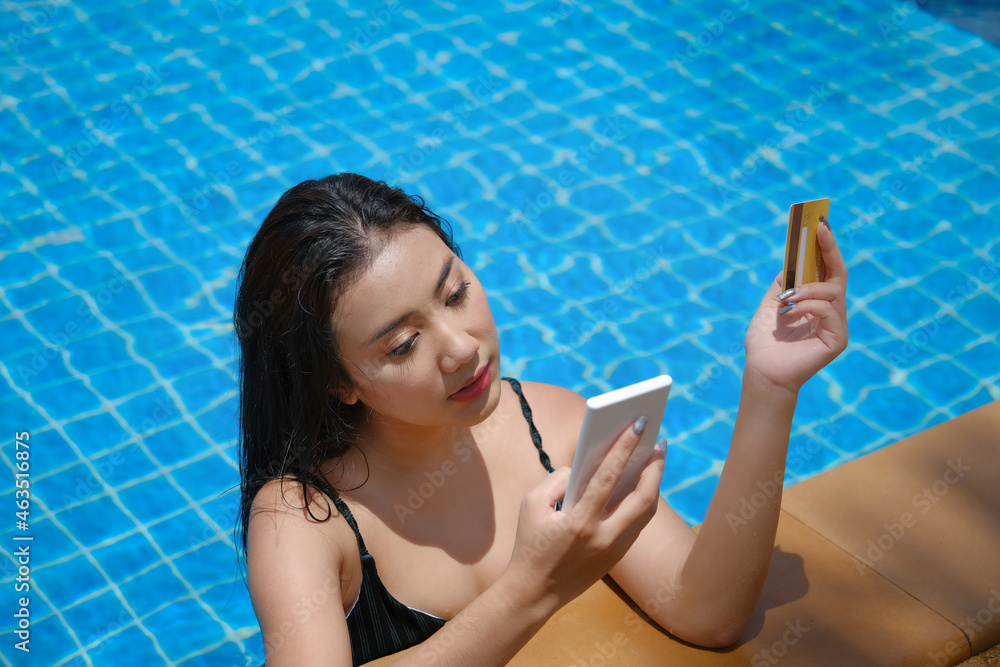 online payment, A teenage girl who swims is using her credit card with her phone to make purchases. online via internet.