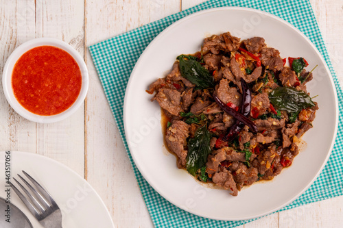 Flat lay Stir-fried holy basil beef slices, pad kaprao neua, a hot and savory Thai dish that can be found from street food carts to restaurants. Holy basil leaves provide the dish with herbal aroma. photo