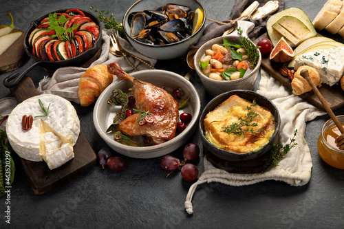 French food assortment on dark background.