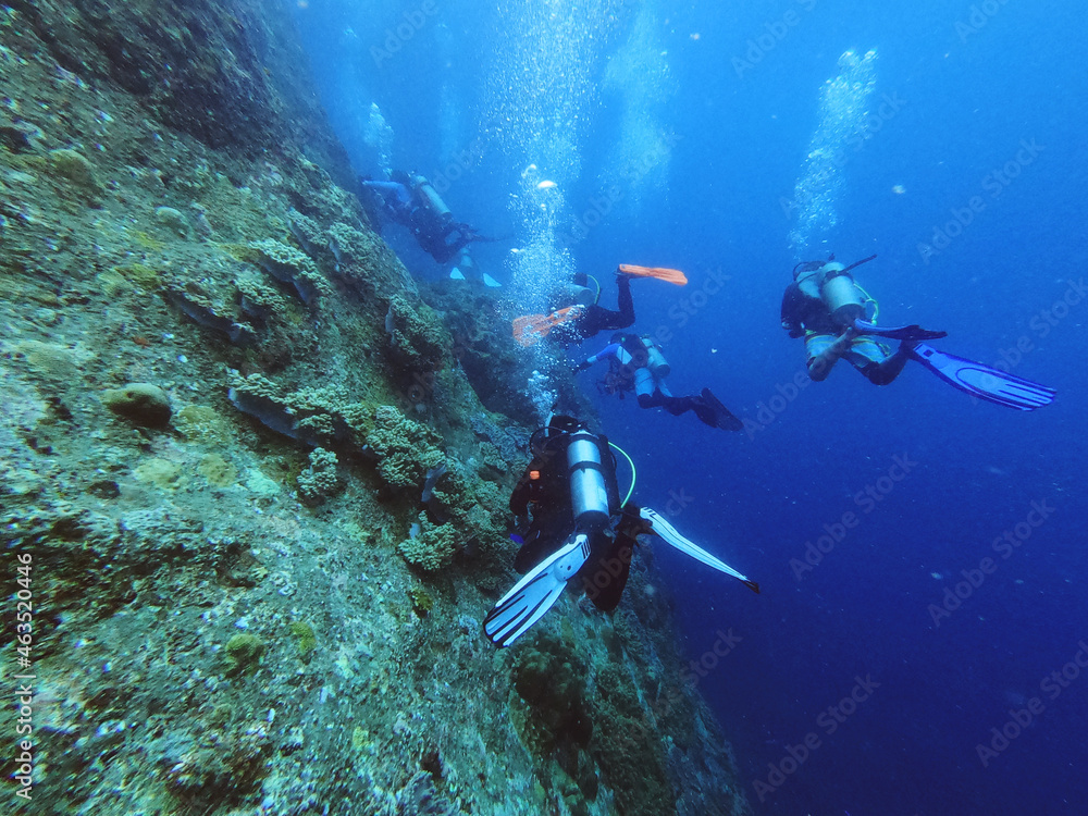 Divers having fun in the deep ocean
