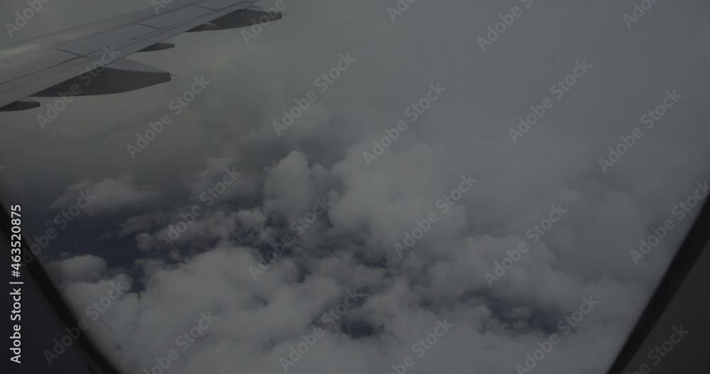 View from the window of an airplane above the clouds View from the window of an airplane above the clouds
