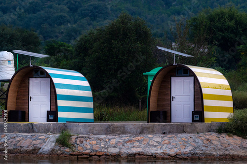 beautiful landscape of lake with colourful cottages and pods in the mountains  photo