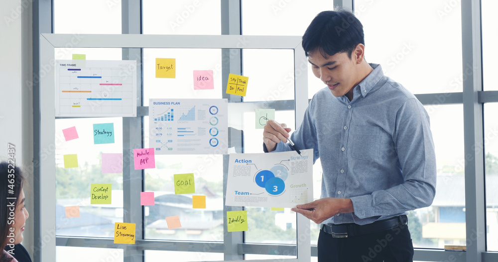 Happy business people meeting present graph chart investment, business data in meeting room. Group of business people meeting in conference room. Asian businessman speech, present teamwork partnership Happy business people meeting present graph chart investment, business data in meeting room. Group of business people meeting in conference room. Asian businessman speech, present teamwork partnership