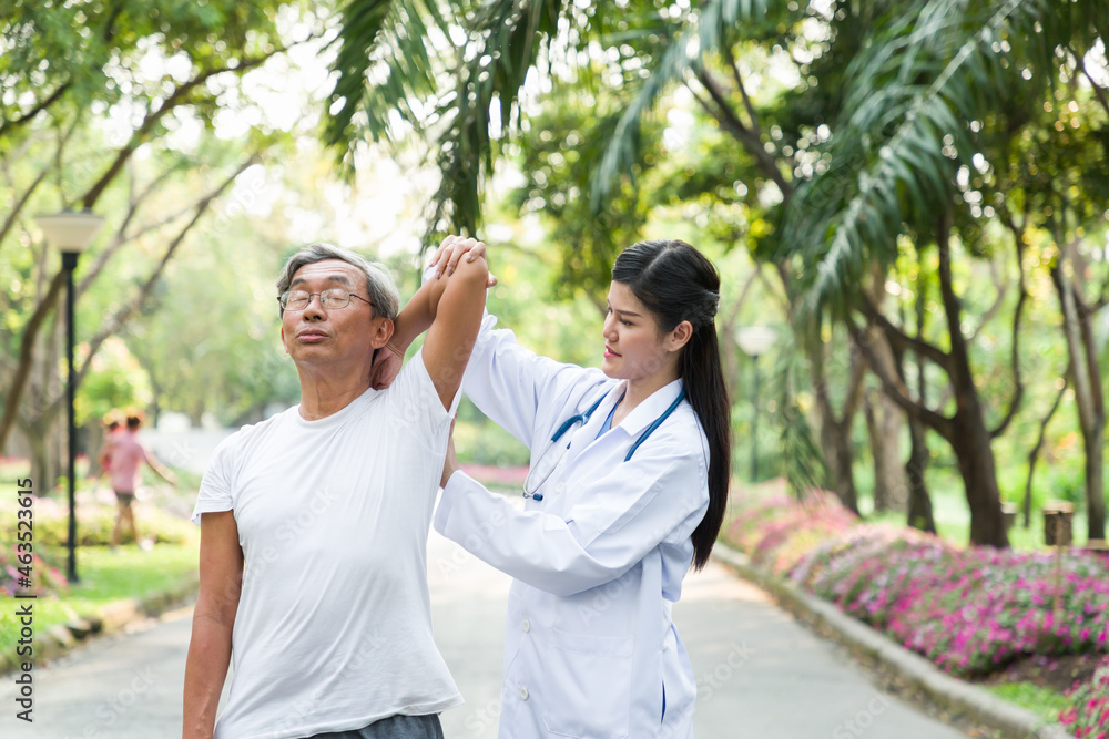 Asian young woman nurse taking care of an elderly man patient in the garden. Young happy doctor with older man outdoor with nature background. Asian young woman nurse taking care of an elderly man patient in the garden. Young happy doctor with older man outdoor with nature background.