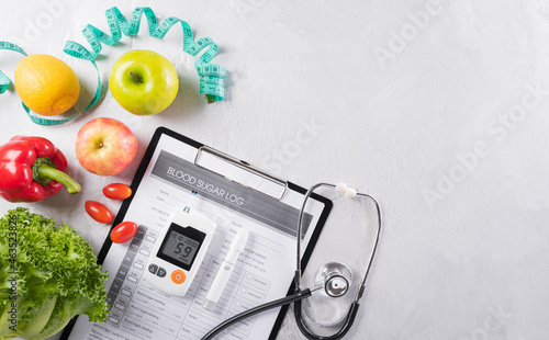 World diabetes day and healthcare concept. Diabetic measurement set, patient's blood sugar control and healthy food eating nutrition in plate on stone background.