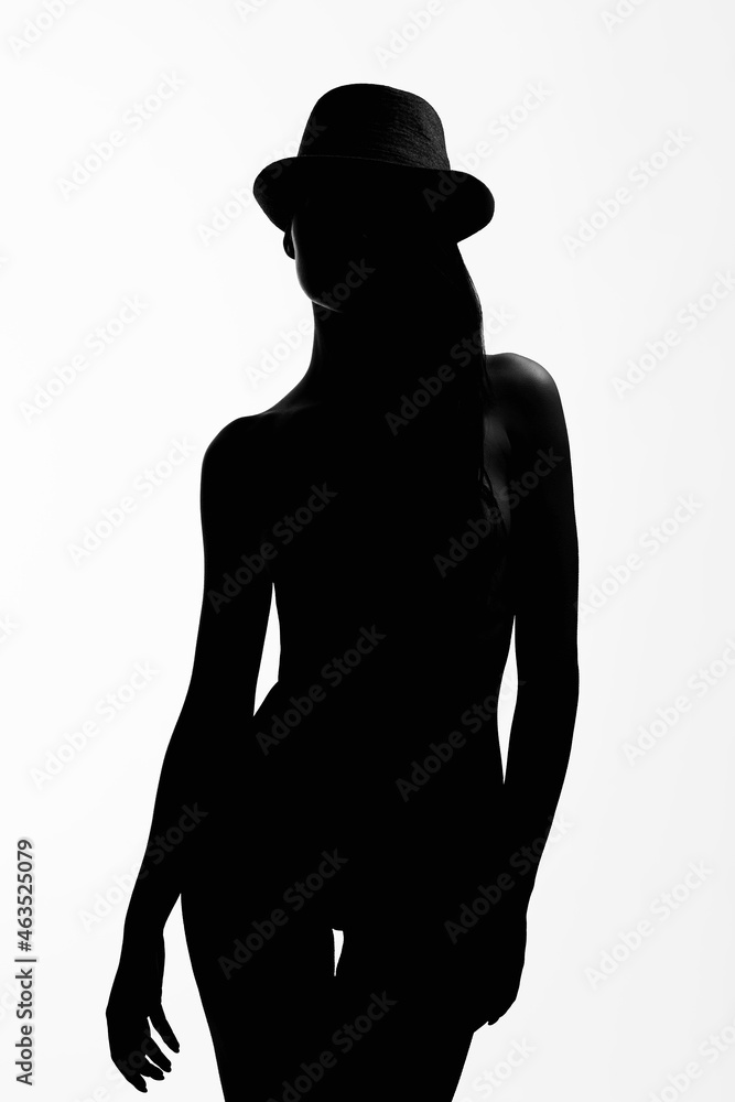Female silhouette. Naked Girl in Hat. Black and white contour