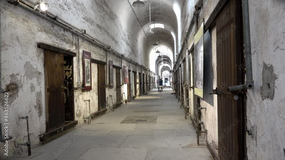 Prison cell block at Eastern State Penitentiary from right side of aisle.