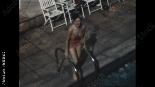 Toe in Pool 1949 - A womans tests the wather with her toe.   photo