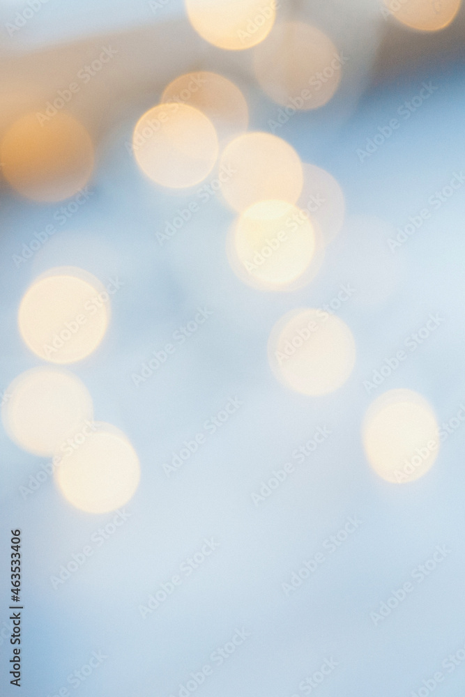 many blurred small electric bulbs on a wall. Yellow blurred lights. Wall of Christmas lights