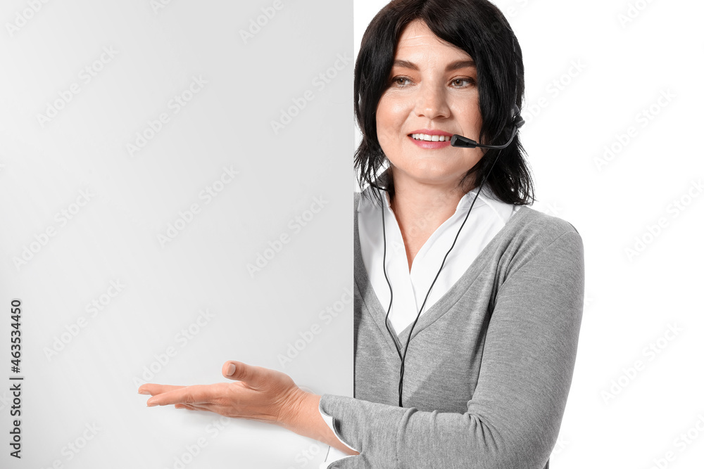 Mature female consultant of call center with blank poster on white background Mature female consultant of call center with blank poster on white background