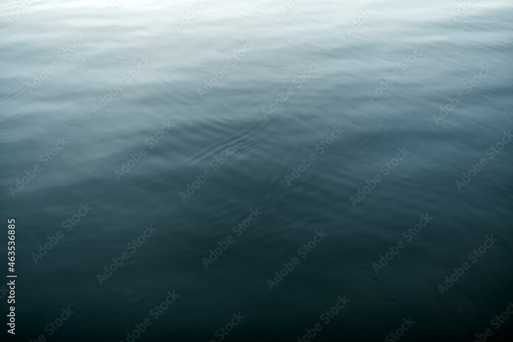 The surface of the water with a gradient of color from dark to light