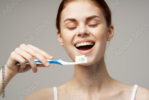 cheerful woman in white t-shirt dental hygiene health care isolated background
