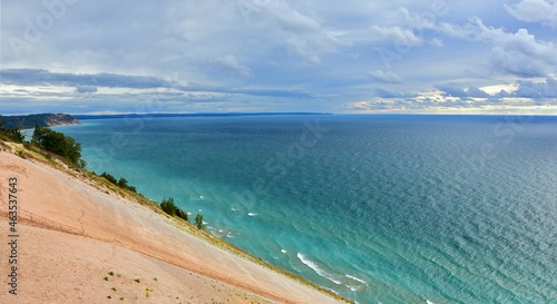 a stunning view across the turquoise-colored water of lake michigan and sand dunes from the lake michigan overlook in sleeping bear dunes national lakeshore in the lower peninsula of michigan