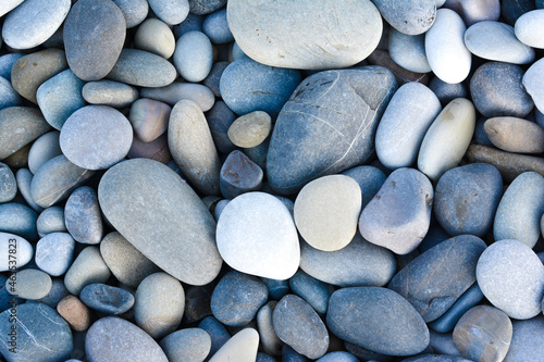 Abstract background with round pebble stones. Stones beach smooth. Top view. photo