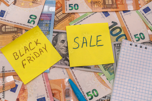 black friday write on memo, dollar and euro money for shopping.