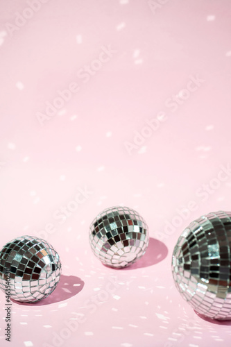 Background of colorful Christmas decor on a pink background. Shiny balls on a pink background.