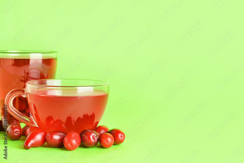 Cups of healthy dogwood berry drink on color background Cups of healthy dogwood berry drink on color background