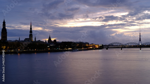 Autumn sunrise in Riga over the Daugava river against the background of the old town and the railway bridge