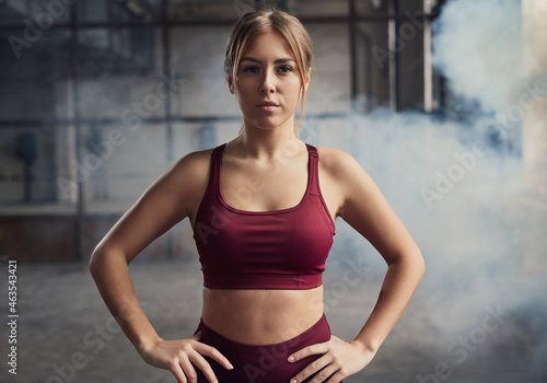 Confident sportswoman in active wear in gym