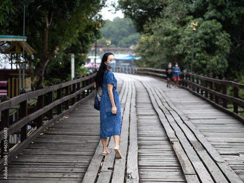 Young beautiful asian woman at Auttamanusorn Wooden Bridge (Sapan Mon) Kanchanaburi , Thailand when she have holiday vacation © Jatuporn