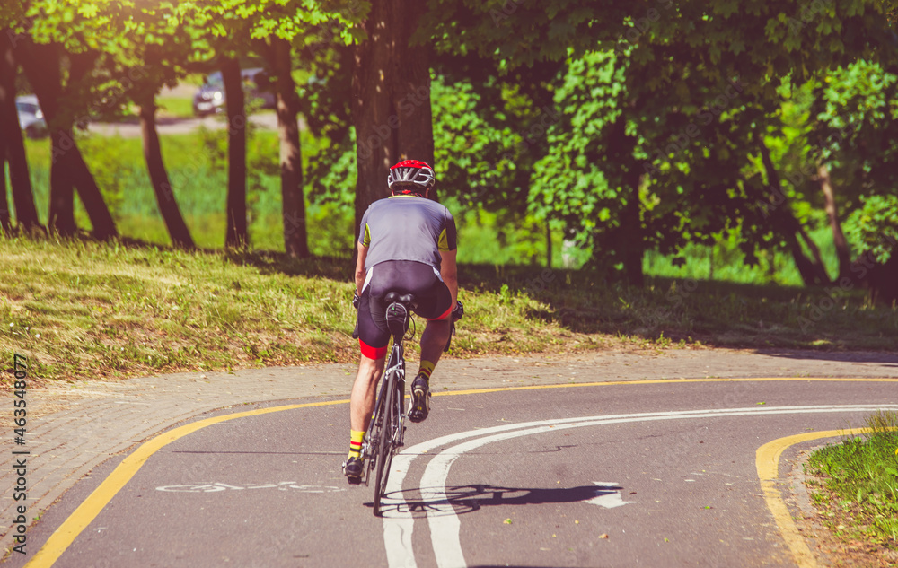 Fototapeta premium Cyclist ride on the bike path in the city Park 