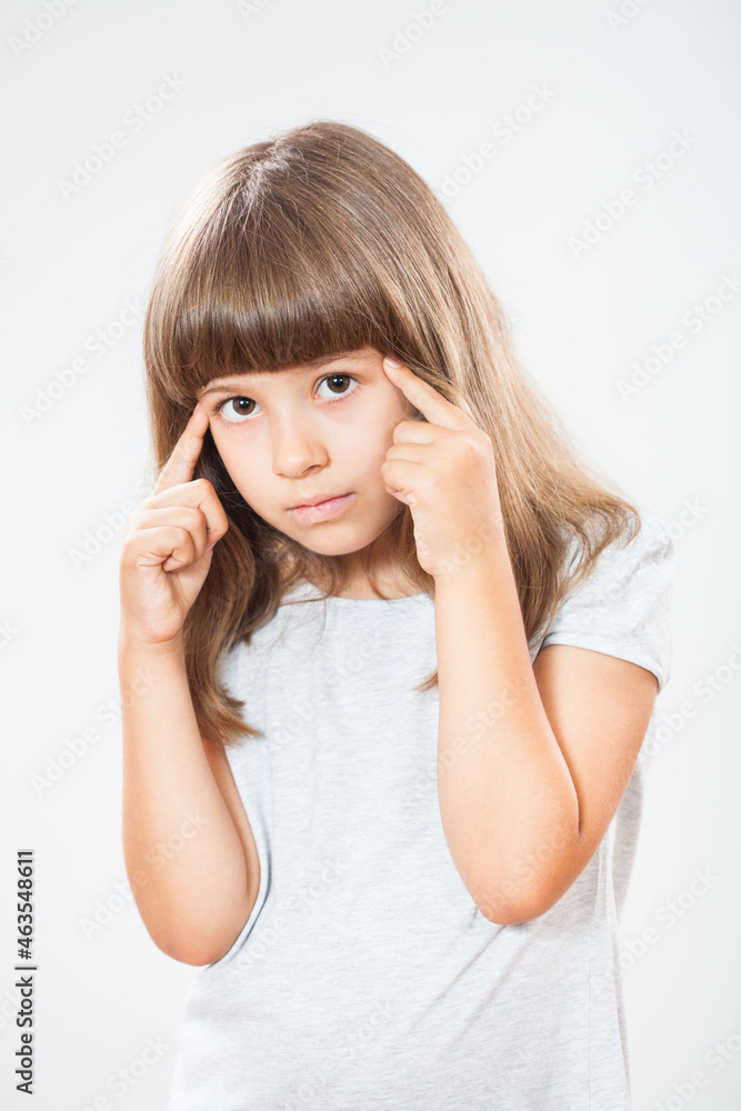 Studio shot portrait of thoughtful little girl. Copy space on gray background. Studio shot portrait of thoughtful little girl. Copy space on gray background.
