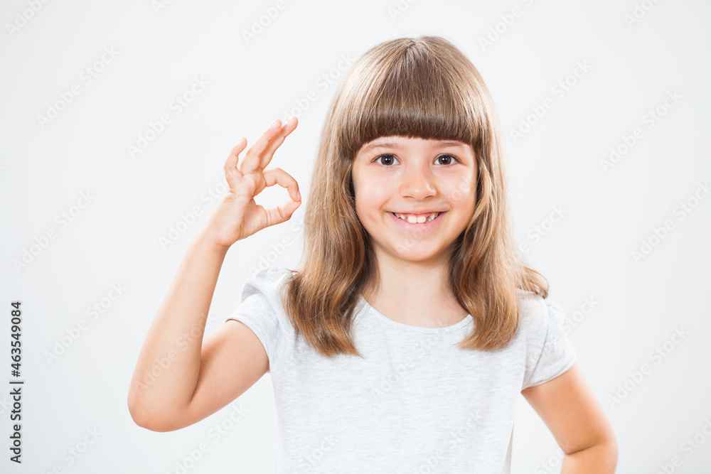 Studio shot portrait of happy little girl. Copy space on gray background. Studio shot portrait of happy little girl. Copy space on gray background.
