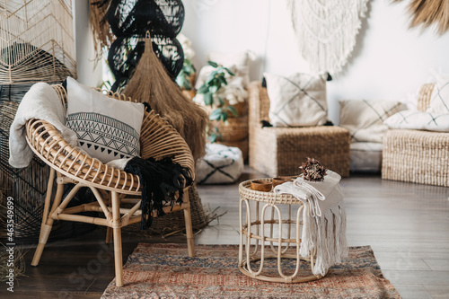 Comfortable furniture in living room with boho interior