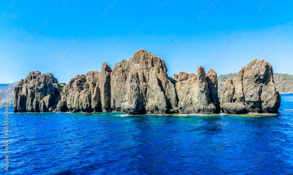 Uninhabited Dislice Island (Dişlice Ada) or Island of Teeth on Aegean Sea. Turkey. Got its name from the fact that from a height it looks like an open mouth of a dragon with giant teeth. Uninhabited Dislice Island (Dişlice Ada) or Island of Teeth on Aegean Sea. Turkey. Got its name from the fact that from a height it looks like an open mouth of a dragon with giant teeth.