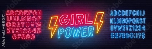 Girl Power neon lettering on brick wall background.