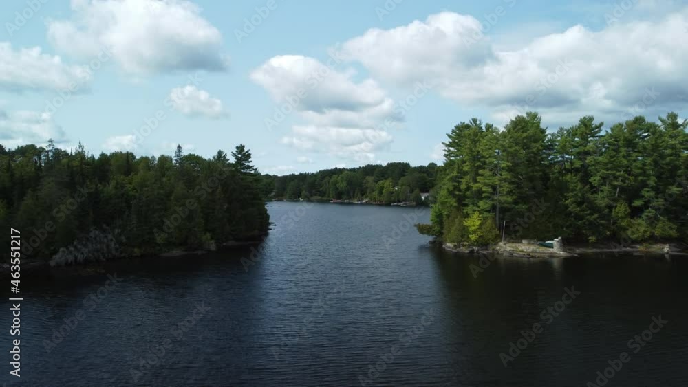 A row of docks sits opposite a channel on a lake A row of docks sits opposite a channel on a lake