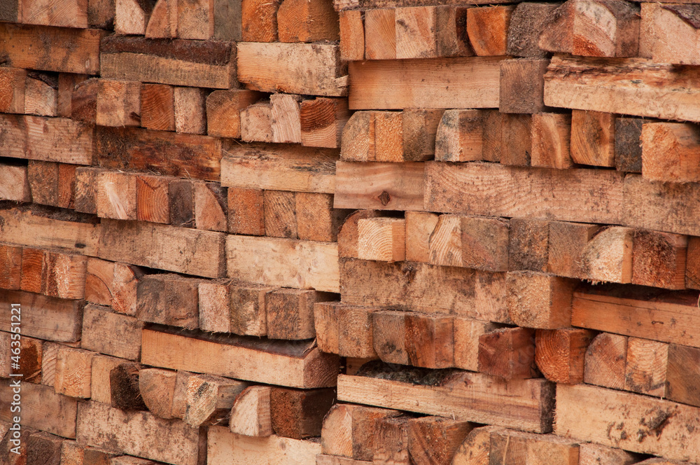 stacked chopped firewood. timber bars at a sawmill. wood background. stacked chopped firewood. timber bars at a sawmill. wood background.