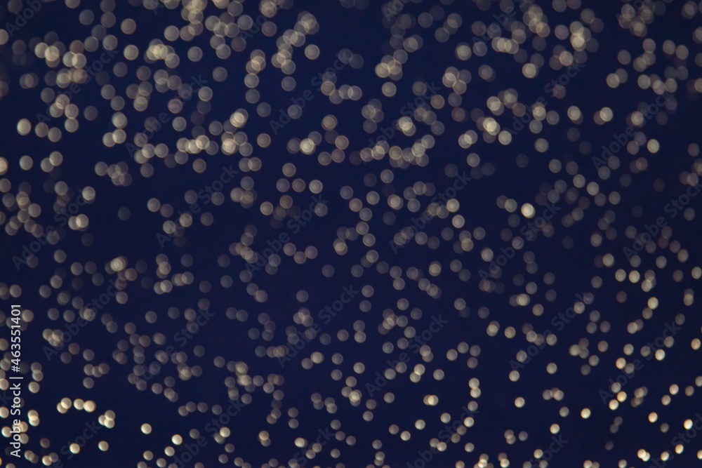 abstract background blue bokeh circles. Dark background with small sparks. abstract background blue bokeh circles. Dark background with small sparks.