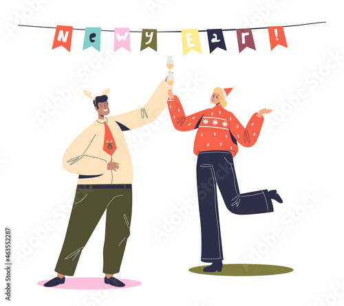 Cheerful man and woman dancing on corporate new year party. Happy coworkers celebrate christmas