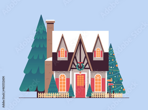 snow covered decorated house winter season home building with decorations for new year and christmas celebration