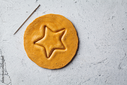 Dalgona Candy - South Korean treat. Round sugar cookie with star inside. photo