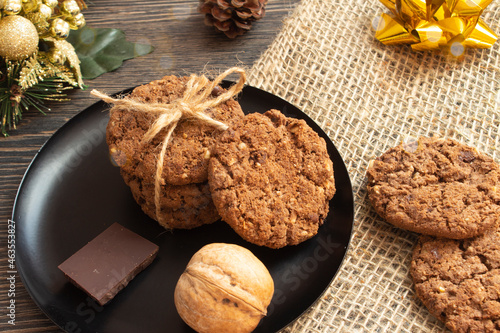 Homemade Christmas cookies with nuts and chocolate. Festive sweets, handmade. Food for the new year. Beautiful warm cozy background with bokeh