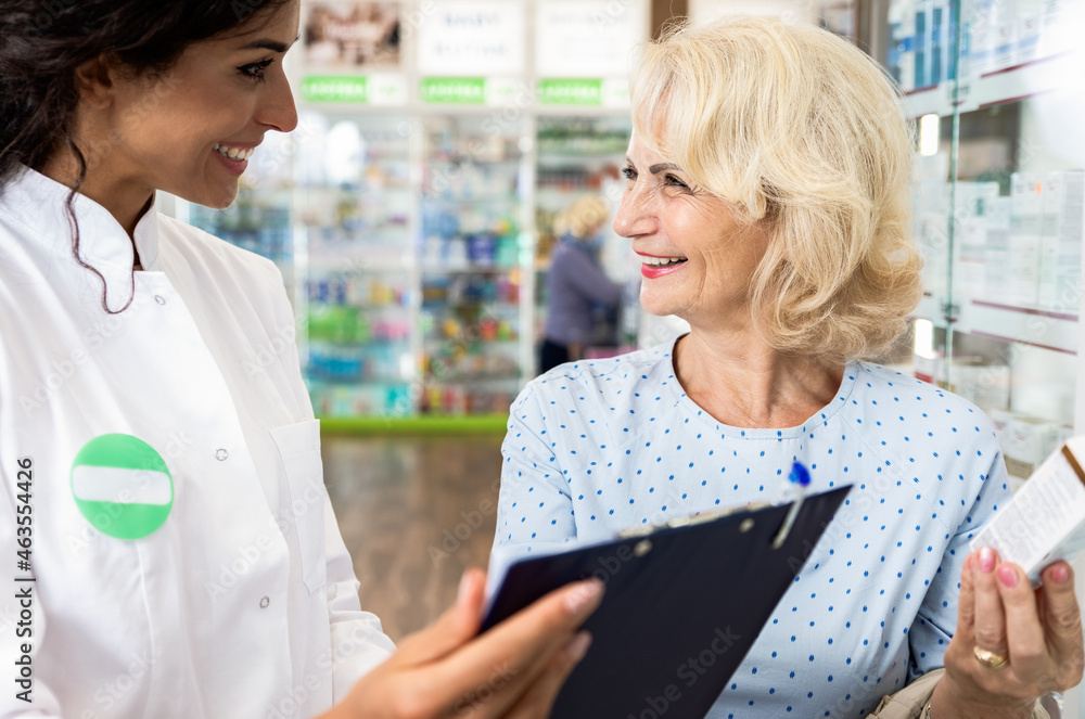 Pharmacist selling medications to senior female customer in the pharmacy store. Pharmacist selling medications to senior female customer in the pharmacy store.